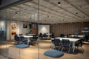 a conference room with tables and chairs and a glass wall at Rose & Golf at Rose Apple Square in Siem Reap +41 photos