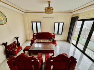 a living room with a table and chairs and a couch at Lùma Sapa Homestay in Sapa