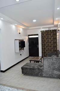a living room with a couch and a table at Kivuli suites in Eldoret