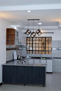a large kitchen with a island in the middle at Kivuli suites in Eldoret