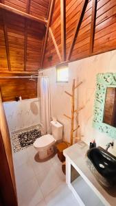 a bathroom with a toilet and a sink at Volcano Valley in Kintamani +42 photos