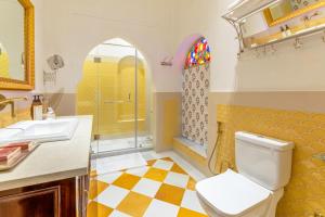 a bathroom with a toilet and a sink and a shower at Abheygarh in Khetri