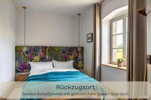 a bedroom with a bed with a colorful headboard at Hufe 9 Gute Stube - Digital Detox und Entschleunigen oder Aktiv-Urlaub in der Natur - Bauernhof Charme trifft modernes Design in Wustrow +31 photos