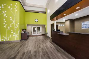 an empty lobby of a hospital with a clock on the wall at Sleep Inn & Suites Valdosta Mall Area in Valdosta +34 photos