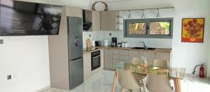 a kitchen with a glass table and chairs in it at villa kate view in Ratzaklíon