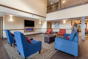 a lobby with blue chairs and a living room at Comfort Inn & Suites Geneva- West Chicago in Geneva