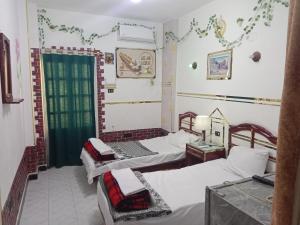 a room with two beds and a window at Four Seasons Hotel in Hurghada +95 photos
