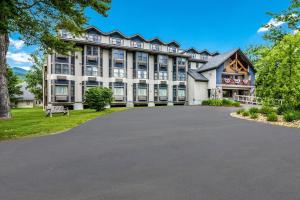a large building with a driveway in front of it at The Valley Inn, an Ascend Collection Hotel in Waterville Valley