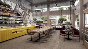a restaurant with tables and chairs in a room at Dizengoff 99 by Isrotel Design in Tel Aviv