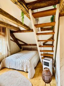 a bedroom with a bed and a staircase at Casa Ribeiro Sotao in Bischberg