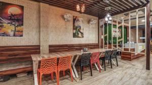 a dining room with a wooden table and chairs at Utkarsh Hotel & Lodging in Jāmkhed
