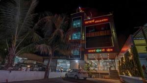a car parked in front of a building at night at Utkarsh Hotel & Lodging in Jāmkhed