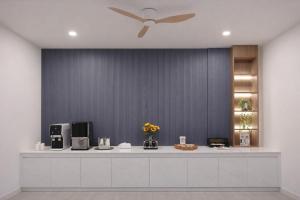 a room with a white counter with a ceiling fan at Northerly นอร์ทเทอร์ลี่ in Chiang Rai