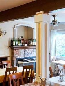 a dining room with a table and a fireplace at 伊豆集 Episode IZU in Ito