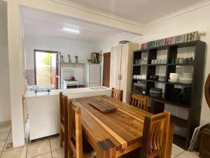a kitchen with a wooden table in a room at Manasseh in Riversdale +5 photos