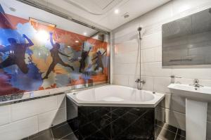 a bathroom with a tub and a sink at S One Hotel in Busan +48 photos