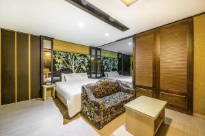 a hotel room with a bed and a couch at S One Hotel in Busan