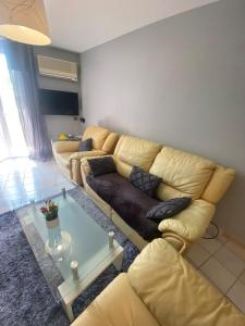 a living room with a couch and a coffee table at Les Bruyères in Martigues
