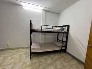 a small room with a bunk bed in it at Frog Guesthouse in Phnom Penh