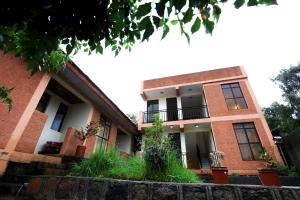 a brick building with plants in front of it at Budget Gest House in Lalibela