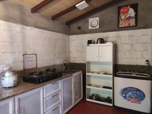 a kitchen with a stove and a refrigerator at Mi casa in Kandy