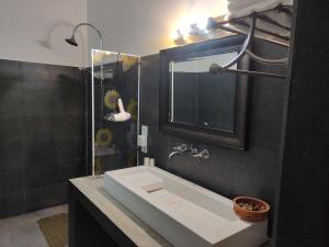 a bathroom with a white sink and a mirror at Mi casa in Kandy +32 photos
