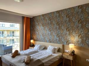 a bedroom with a large bed and a window at VR Spa Apartman in Velence