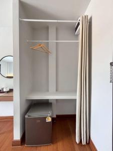 a walk in closet with a shelf and a drawer at Ma Relax Place in Ban Nong Chaeng