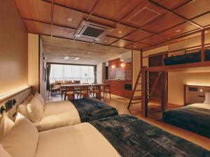 a bedroom with two beds and a bunk bed at illi Nuto Shinjuku in Tokyo
