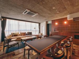 a living room with a large table and chairs at illi Nuto Shinjuku in Tokyo