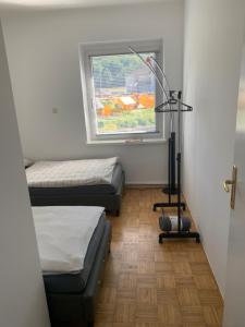 a room with two beds and a window at Wohnung Nähe Steyr bis 9 Personen in Ramingdorf