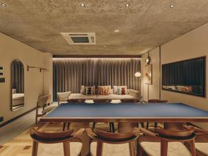 a living room with a table and a couch at illi Nuto Shinjuku in Tokyo +68 photos
