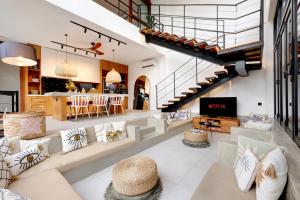 an open living room with a couch and a table at Baliwood Residence Villas by BREIG in Munggu