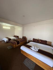 a hotel room with two beds in it at Delohighs in Kalimpong +44 photos