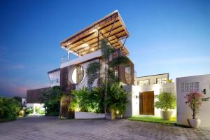 a building with a lot of plants in front of it at Baliwood Residence Villas by BREIG in Munggu