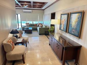 a large living room with a couch and chairs at Pent House Executive Resedency in Dargai