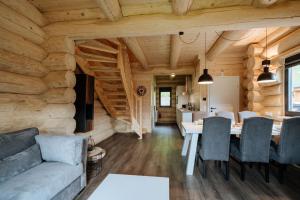 a living room with a table and a couch at Luxury Chalet near Ski Slopes in Jenig
