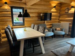 a dining room with a table and chairs at Luxury Chalet near Ski Slopes in Jenig +13 photos