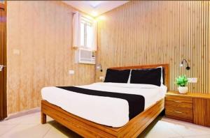 a bedroom with a large bed in a room at RROOMS Eco Hotel Blue Stone- Near Singapore Mall And Max Hospital in Lucknow