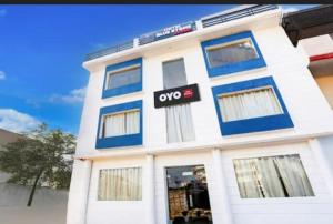 a white building with a qop sign on it at RROOMS Eco Hotel Blue Stone- Near Singapore Mall And Max Hospital in Lucknow
