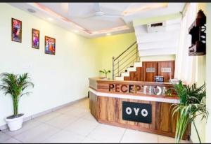 a lobby with aope tuo sign in a building at RROOMS Eco Hotel Blue Stone- Near Singapore Mall And Max Hospital in Lucknow