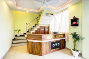an office lobby with a reception desk and stairs at RROOMS Eco Hotel Blue Stone- Near Singapore Mall And Max Hospital in Lucknow