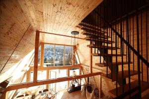 an overhead view of a wooden house with a spiral staircase at Cabana KayLuna in Mătişeşti