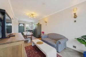 a living room with a couch and a table at Lloyd's Corner in Cape Town