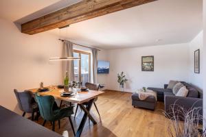 a living room with a table and a couch at Appartement Penningdörfl in Hopfgarten im Brixental