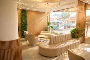 a lobby with a couch and chairs and a table at HAO LAN LUXURY Hotel in Bắc Quang
