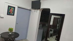 a room with a table and a mirror and a table at Dream Paradise Apartment in Korotogo