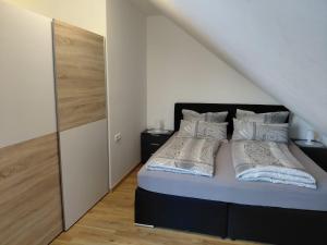 a bedroom with a bed with two pillows at Hinter-Apartments-Nord in Rohrbach