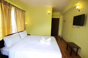 My Hotel Pvt Ltd tesisinde bir odada yatak veya yataklar