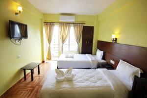 My Hotel Pvt Ltd tesisinde bir odada yatak veya yataklar